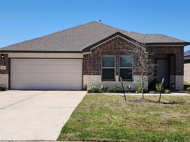 ranch-style house featuring an attached garage, brick siding, a shingled roof, concrete driveway, and a front yard