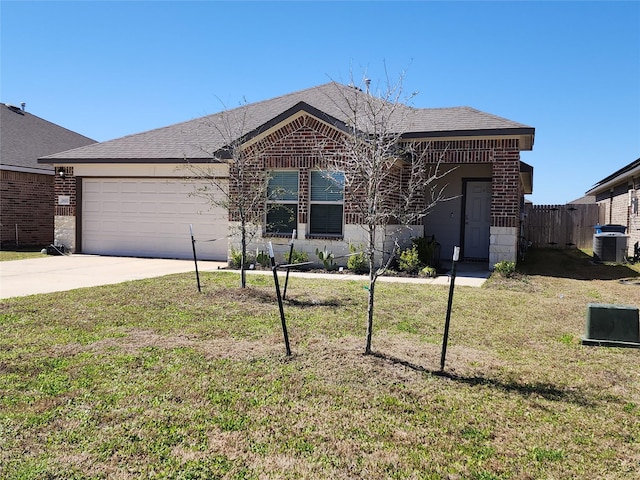 single story home featuring a garage, concrete driveway, brick siding, and a front yard