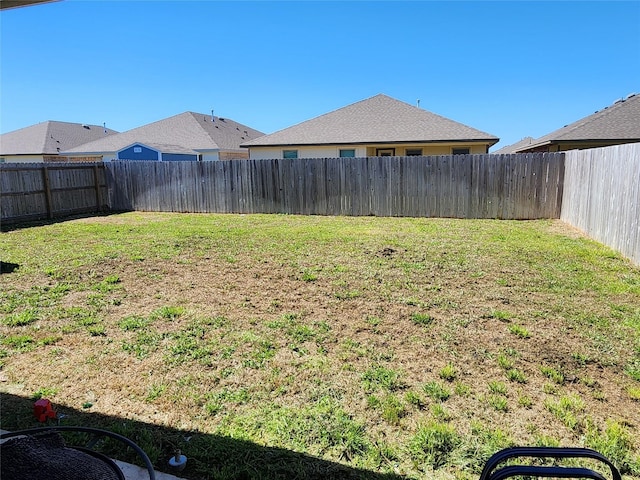 view of yard with a fenced backyard