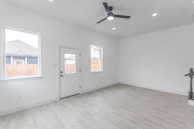 interior space with light wood finished floors, ceiling fan, baseboards, and recessed lighting