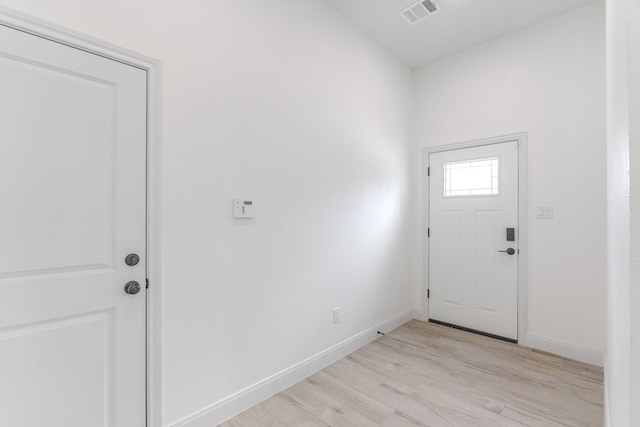 entryway with light wood-style floors, visible vents, and baseboards