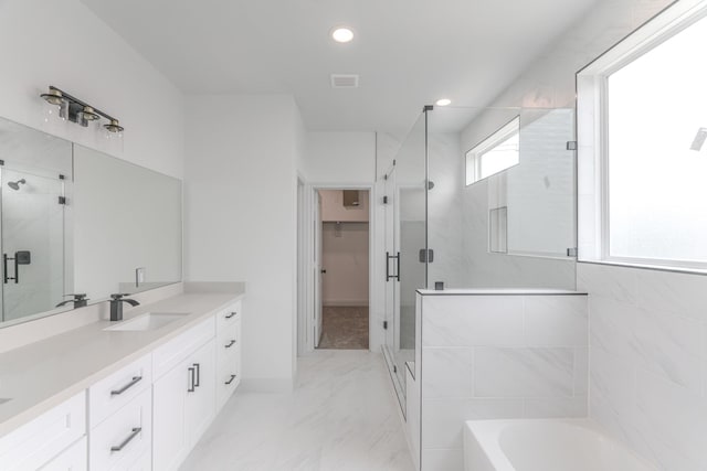 full bathroom featuring marble finish floor, a garden tub, visible vents, a stall shower, and vanity