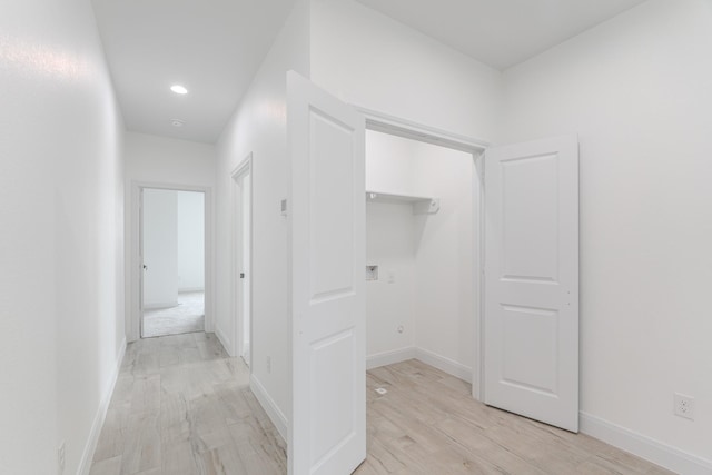 hallway with recessed lighting, baseboards, and light wood finished floors