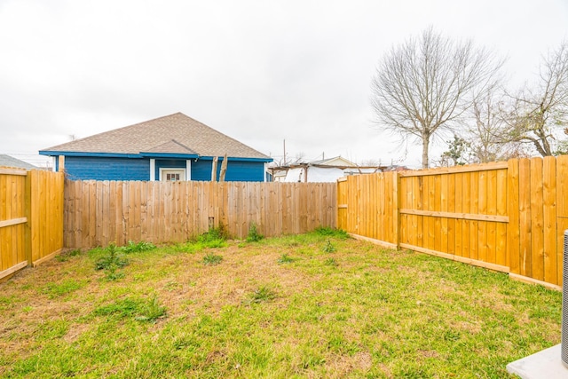 view of yard with a fenced backyard