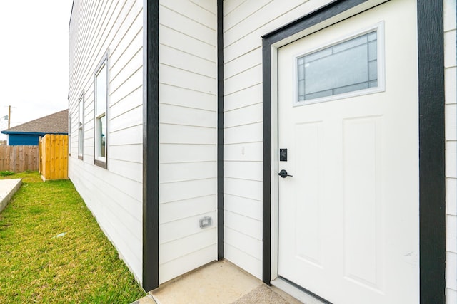 doorway to property featuring fence