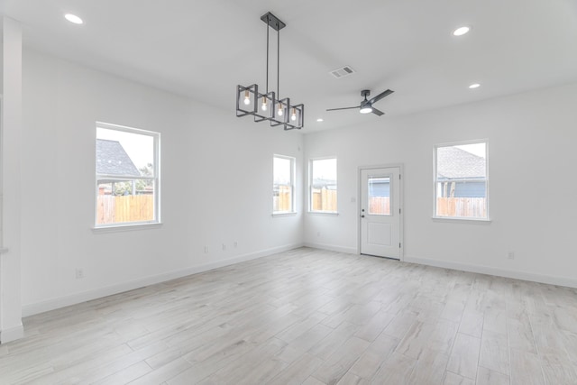 unfurnished room featuring light wood-style floors, baseboards, visible vents, and recessed lighting