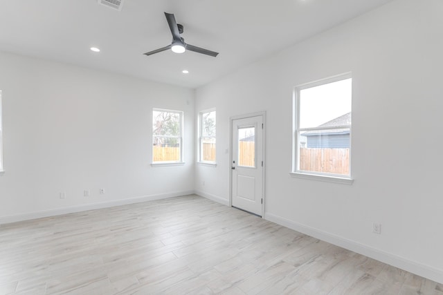 empty room with recessed lighting, visible vents, light wood-style flooring, ceiling fan, and baseboards