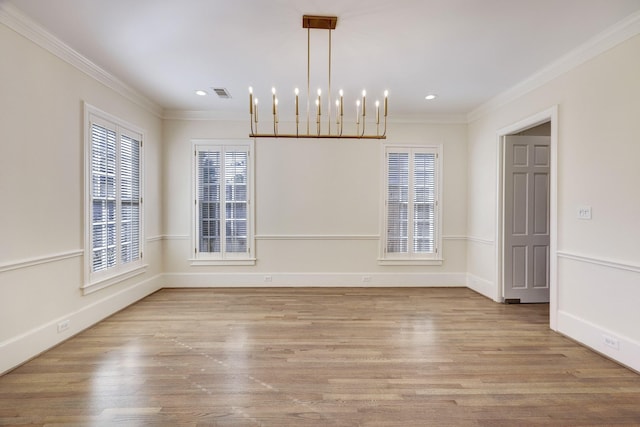 unfurnished dining area with ornamental molding, visible vents, baseboards, and wood finished floors