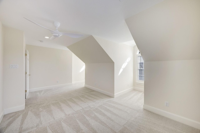 additional living space with lofted ceiling, a ceiling fan, baseboards, and carpet flooring