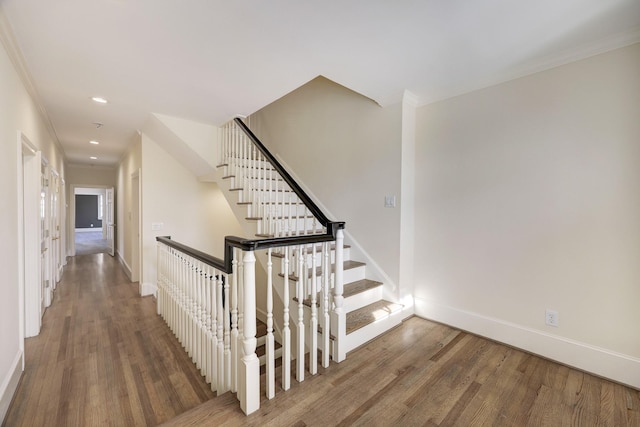 stairs featuring crown molding, baseboards, wood finished floors, and recessed lighting