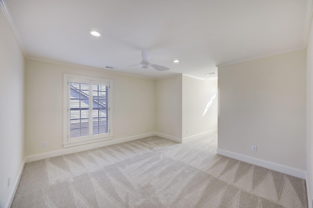 spare room with ornamental molding, recessed lighting, light carpet, and baseboards