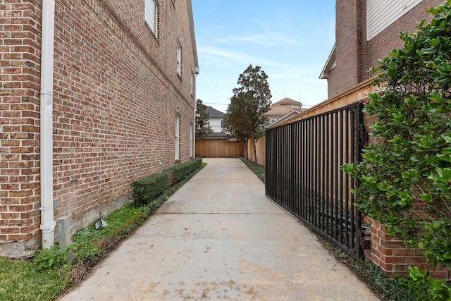 view of home's exterior featuring brick siding and fence