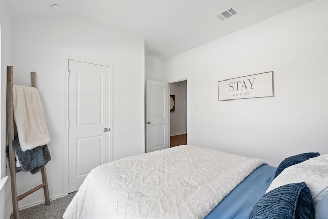 carpeted bedroom featuring baseboards and visible vents