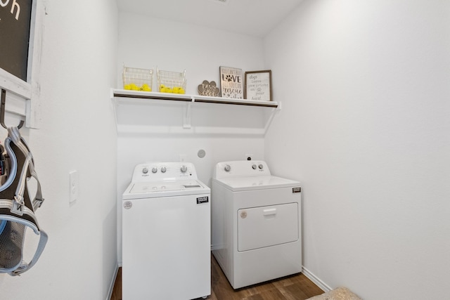 laundry room featuring laundry area, dark wood finished floors, baseboards, and separate washer and dryer