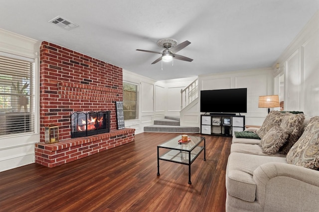 17302 Loring Ln, Spring, TX 77388 - living room featuring a decorative wall, wood finished floors, a brick fireplace, a ceiling fan, and crown molding