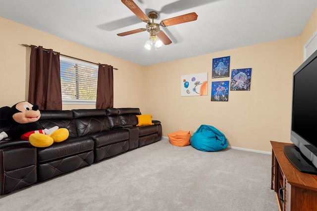 carpeted living area with a ceiling fan and baseboards