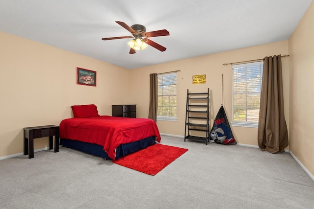 carpeted bedroom featuring ceiling fan and baseboards