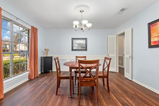 dining room with a notable chandelier, visible vents, dark wood-style flooring, and a wealth of natural light