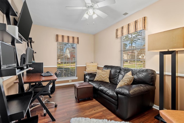 office space with a wealth of natural light, ceiling fan, baseboards, and wood finished floors