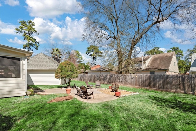 view of yard featuring a patio area, fence, and a fire pit