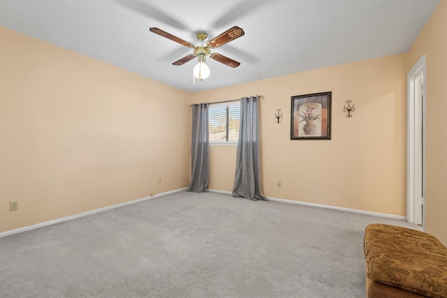 unfurnished room with carpet flooring, a ceiling fan, and baseboards