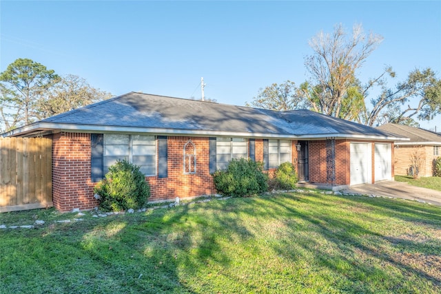 ranch-style home with brick siding, a shingled roof, a garage, driveway, and a front lawn