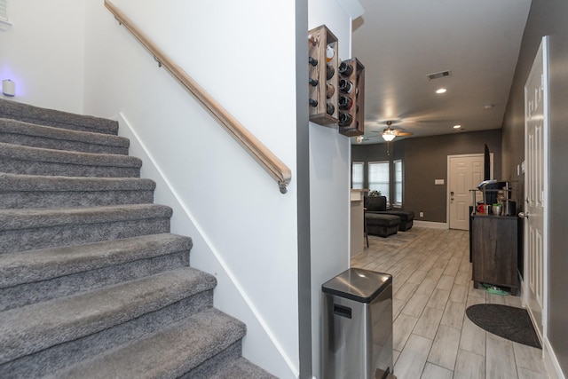 stairway featuring ceiling fan, recessed lighting, visible vents, baseboards, and wood tiled floor