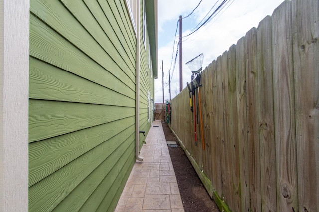 view of side of property featuring fence