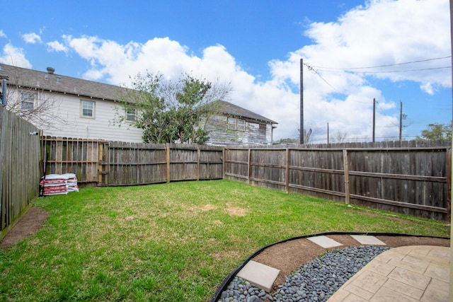 view of yard with a patio area and a fenced backyard