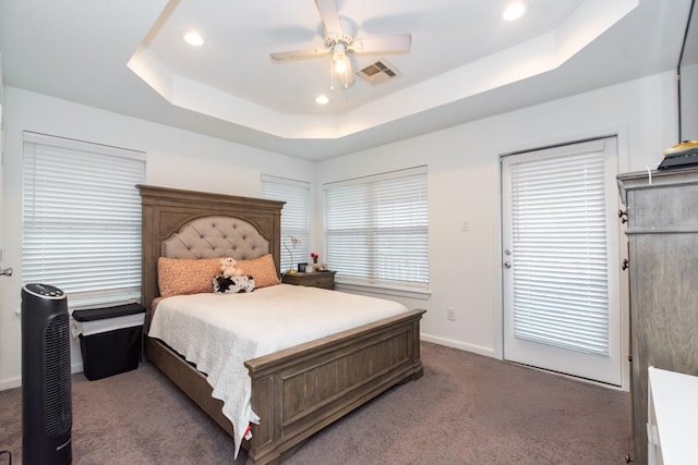 carpeted bedroom featuring recessed lighting, a raised ceiling, visible vents, ceiling fan, and baseboards