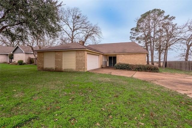 ranch-style house featuring concrete driveway, a chimney, an attached garage, fence, and a front lawn