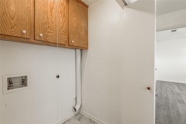 washroom featuring cabinet space, baseboards, visible vents, hookup for a washing machine, and marble finish floor