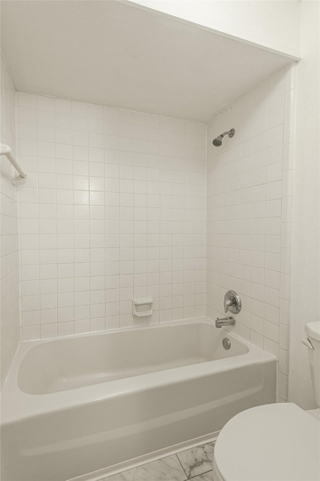 full bathroom with toilet, marble finish floor, and  shower combination