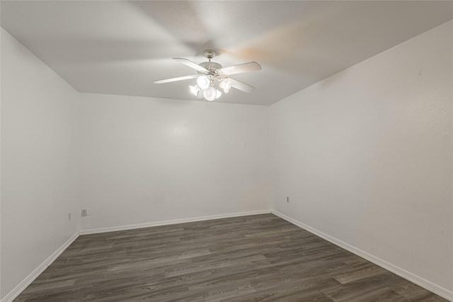 empty room with dark wood-style floors, baseboards, and a ceiling fan