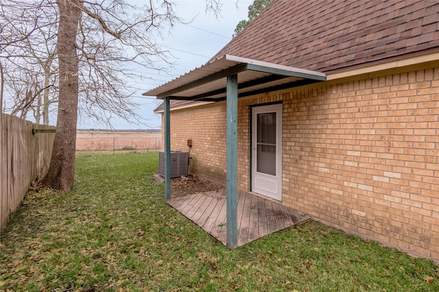 exterior space featuring cooling unit, a fenced backyard, and a yard