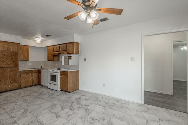 kitchen featuring white appliances, visible vents, brown cabinetry, marble finish floor, and light countertops