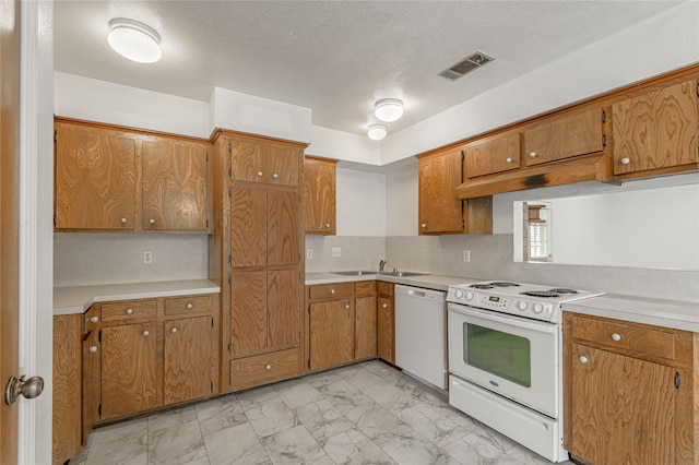 kitchen with marble finish floor, light countertops, visible vents, a sink, and white appliances