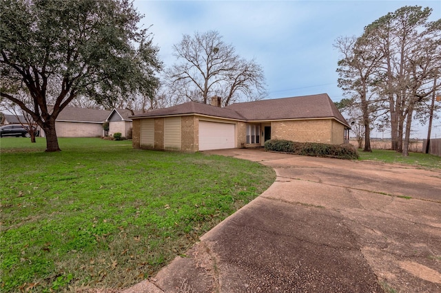 view of front of house featuring brick siding, a chimney, a front yard, a garage, and driveway