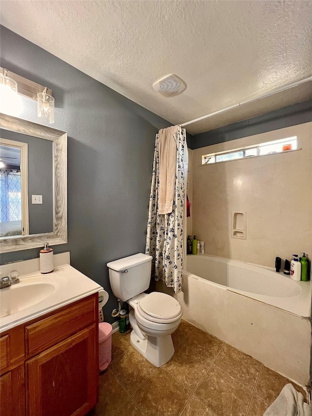 bathroom featuring plenty of natural light, a textured ceiling, toilet, and vanity