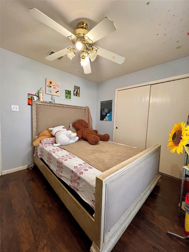 bedroom with ceiling fan, wood finished floors, and baseboards