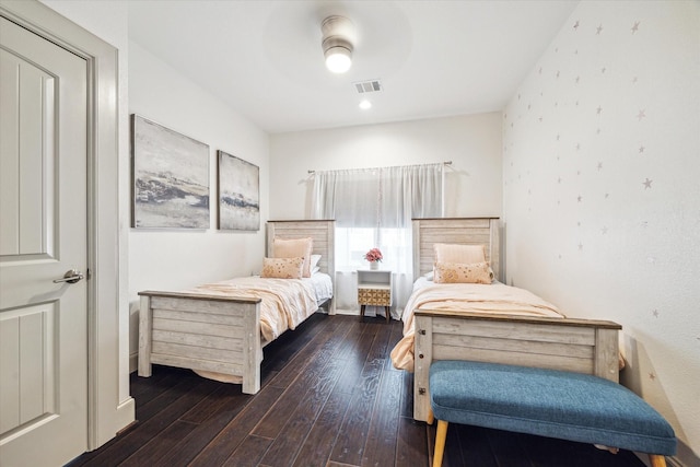 bedroom featuring visible vents, wood-type flooring, and a ceiling fan