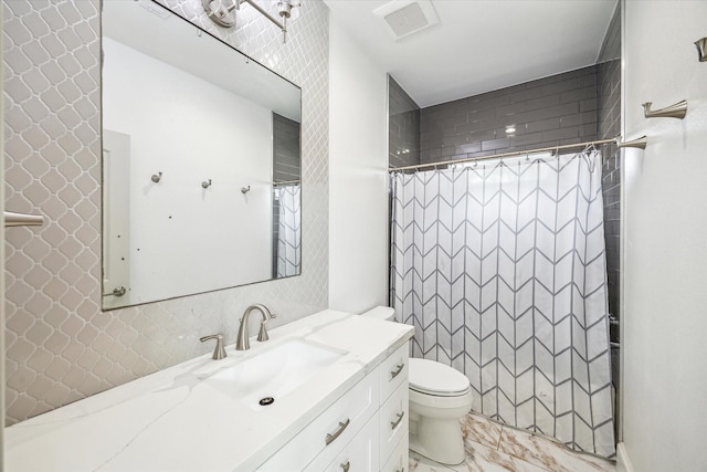 bathroom with toilet, marble finish floor, curtained shower, and vanity