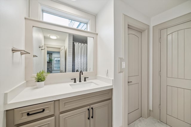 bathroom with marble finish floor and vanity