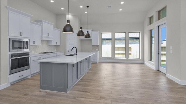 21207 Palm Arbor Dr, Cypress, TX 77433 - kitchen with stainless steel appliances, plenty of natural light, recessed lighting, decorative backsplash, and a towering ceiling