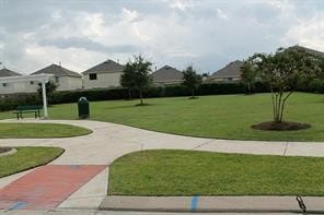 view of property's community with a yard