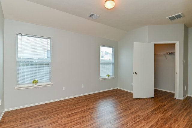 unfurnished bedroom featuring visible vents, baseboards, and wood finished floors