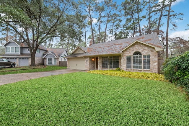 view of front of home with a garage, a front yard, concrete driveway, and brick siding