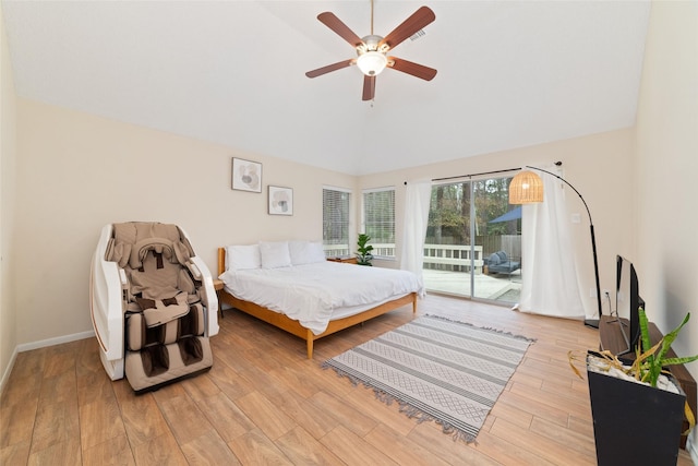 bedroom featuring lofted ceiling, ceiling fan, light wood-style floors, baseboards, and access to exterior