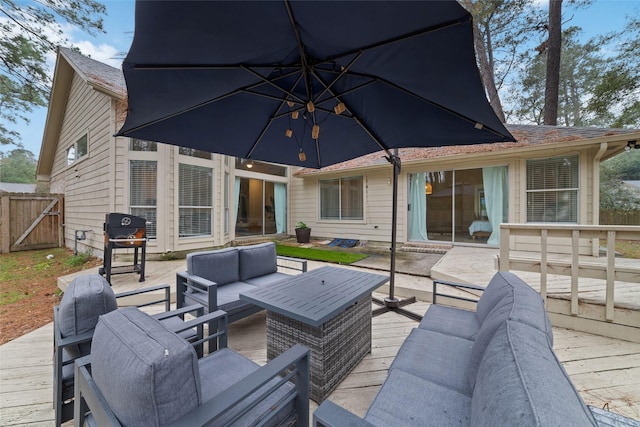 view of patio / terrace with area for grilling, outdoor lounge area, fence, and a wooden deck