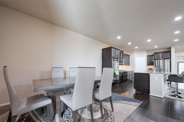 dining room with dark wood-type flooring and recessed lighting